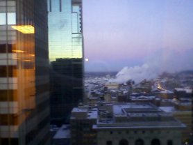 Moon falling in the west and sunrise reflected in the glass towers facing east...amazing. This is from my office window. Straight ahead was new Twins' stadium construction.